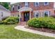 Charming brick home with covered entry, walkway, and professionally landscaped front yard at 12416 Stirling Trace Ct, Charlotte, NC 28277