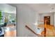Bright hallway with hardwood floors, stairs, and natural light at 12416 Stirling Trace Ct, Charlotte, NC 28277
