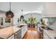 Bright, open kitchen with stainless steel appliances, a kitchen island, and a view into the dining area at 12416 Stirling Trace Ct, Charlotte, NC 28277