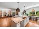 Open concept kitchen and living area featuring a kitchen island and fireplace at 12416 Stirling Trace Ct, Charlotte, NC 28277