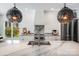 Close-up of a kitchen island featuring a sink, marble countertops and backsplash, and stainless steel appliances at 12416 Stirling Trace Ct, Charlotte, NC 28277