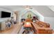 Cozy living room with vaulted ceilings, a comfortable leather couch, and natural light at 12416 Stirling Trace Ct, Charlotte, NC 28277