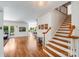 Open-concept living area with hardwood floors, staircase, and a view to the dining room at 12416 Stirling Trace Ct, Charlotte, NC 28277