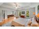 Bright main bedroom boasts a tray ceiling, wood floors, a sitting area, and ample natural light at 12416 Stirling Trace Ct, Charlotte, NC 28277