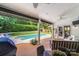 Covered patio view featuring an in-ground pool, wood flooring, ceiling fans and comfortable seating areas at 12416 Stirling Trace Ct, Charlotte, NC 28277