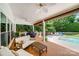 Covered patio with outdoor seating and view of the pool and backyard at 12416 Stirling Trace Ct, Charlotte, NC 28277