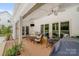 Cozy, partially covered patio with plenty of seating and outdoor dining space at 12416 Stirling Trace Ct, Charlotte, NC 28277