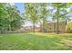 Expansive backyard featuring a well-maintained lawn and mature trees, perfect for outdoor activities at 12434 Sylvan Oak Way, Charlotte, NC 28273