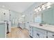 Bright bathroom featuring dual sinks, modern fixtures, and a walk-in shower at 12434 Sylvan Oak Way, Charlotte, NC 28273