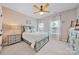 Light-filled bedroom featuring a gray-blue bed frame with a decorative ceiling fan at 12434 Sylvan Oak Way, Charlotte, NC 28273