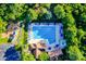 Aerial view of community pool with lounge chairs, umbrellas, and a playground area at 12434 Sylvan Oak Way, Charlotte, NC 28273