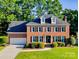Beautiful two-story brick home with manicured lawn, mature trees and traditional architectural details at 12434 Sylvan Oak Way, Charlotte, NC 28273