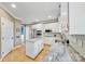Bright kitchen featuring white cabinetry, granite countertops, an island, and stainless steel appliances at 12434 Sylvan Oak Way, Charlotte, NC 28273