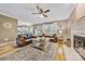 Warm living room with fireplace, ceiling fan, hardwood floors and comfortable seating arrangement at 12434 Sylvan Oak Way, Charlotte, NC 28273