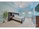 Spacious main bedroom with tray ceilings, fan, and large windows providing natural light at 12434 Sylvan Oak Way, Charlotte, NC 28273