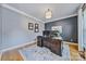 Office with hardwood floors, crown molding, two toned walls, and decorative light fixture at 12434 Sylvan Oak Way, Charlotte, NC 28273