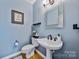 Stylish powder room with blue walls, modern fixtures, and elegant decor at 12434 Sylvan Oak Way, Charlotte, NC 28273