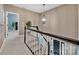 Staircase with carpet runner, wooden railings, and modern lighting fixture at 12434 Sylvan Oak Way, Charlotte, NC 28273