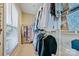 Walk-in closet with ample storage space and natural light from a window with blinds at 12434 Sylvan Oak Way, Charlotte, NC 28273
