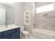 Bathroom featuring a bathtub and shower combination with tiled walls, white toilet, and vanity sink at 14019 Cameryn Elise Dr, Cornelius, NC 28031