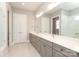Stylish bathroom showcasing a double sink vanity with gray cabinets and a walk-in shower with glass door at 14019 Cameryn Elise Dr, Cornelius, NC 28031