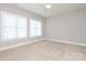 A bedroom with neutral carpet and two windows at 14019 Cameryn Elise Dr, Cornelius, NC 28031