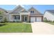 Charming home with a welcoming front porch, brick accents, and a well-manicured lawn at 14019 Cameryn Elise Dr, Cornelius, NC 28031