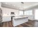 Modern kitchen boasting white cabinetry, granite countertops, and stainless steel appliances at 14019 Cameryn Elise Dr, Cornelius, NC 28031