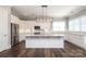 A bright kitchen with stainless steel appliances, white cabinets, subway tile backsplash, and a large island at 14019 Cameryn Elise Dr, Cornelius, NC 28031