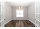 Spacious living room featuring wood flooring and a modern chandelier at 14019 Cameryn Elise Dr, Cornelius, NC 28031