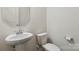 Bathroom with pedestal sink, white toilet, and octagon mirror at 14027 Clayborn St, Midland, NC 28107