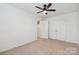 Bedroom with neutral carpet, ceiling fan, and a closet for storage at 14027 Clayborn St, Midland, NC 28107