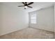 Bedroom with neutral carpet, ceiling fan, and a window letting in natural light at 14027 Clayborn St, Midland, NC 28107