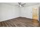 Bright bedroom featuring wood-look flooring, ceiling fan, and neutral color palette at 14027 Clayborn St, Midland, NC 28107