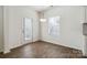 Dining area with hardwood floors, a window, and a door leading to the backyard at 14027 Clayborn St, Midland, NC 28107