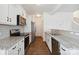 Modern kitchen featuring stainless steel appliances, granite countertops, and white cabinetry at 14027 Clayborn St, Midland, NC 28107