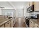 Kitchen with granite countertops and stainless steel appliances open to the dining area at 14027 Clayborn St, Midland, NC 28107