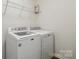 Laundry room features a new washing machine and dryer with storage shelf at 14027 Clayborn St, Midland, NC 28107