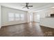 Open-concept living room showcasing hardwood floors and a ceiling fan at 14027 Clayborn St, Midland, NC 28107