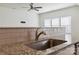 Close-up of stainless steel sink, granite countertop, and light gray subway tile at 14027 Clayborn St, Midland, NC 28107