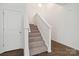 Carpeted stairway with white trim and natural light, leading to the upper level at 14027 Clayborn St, Midland, NC 28107