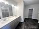 The bathroom features a double sink vanity, tile shower, and modern fixtures and lighting at 1445 Mocksville Hwy # 26, Statesville, NC 28625