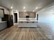 Spacious kitchen featuring a large center island, gray cabinetry, and stainless steel appliances at 1445 Mocksville Hwy # 26, Statesville, NC 28625