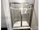 Modern tiled shower with glass doors, a built-in bench, and a shower niche for toiletries at 1445 Mocksville Hwy # 26, Statesville, NC 28625