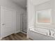 Bright bathroom featuring a tub, separate glass shower, and a window providing natural light at 146 Swann Rd # 9, Statesville, NC 28625