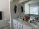 Bathroom vanity with double sinks, a large mirror, white cabinetry, and chrome hardware at 15005 Savannah Hall Dr # 72, Charlotte, NC 28273
