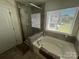 Bathroom with a glass shower, a garden tub, and a window that provides plenty of natural light at 15005 Savannah Hall Dr # 72, Charlotte, NC 28273