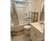 Bathroom featuring a shower-tub combo, toilet, and sink with a cabinet, and a shelf at 15005 Savannah Hall Dr # 72, Charlotte, NC 28273