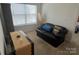 Bedroom with a couch, an oval mirror, a side table, and a window at 15005 Savannah Hall Dr # 72, Charlotte, NC 28273