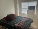 Bedroom featuring large window, chest of drawers with a TV, and a bed with a patterned comforter at 15005 Savannah Hall Dr # 72, Charlotte, NC 28273